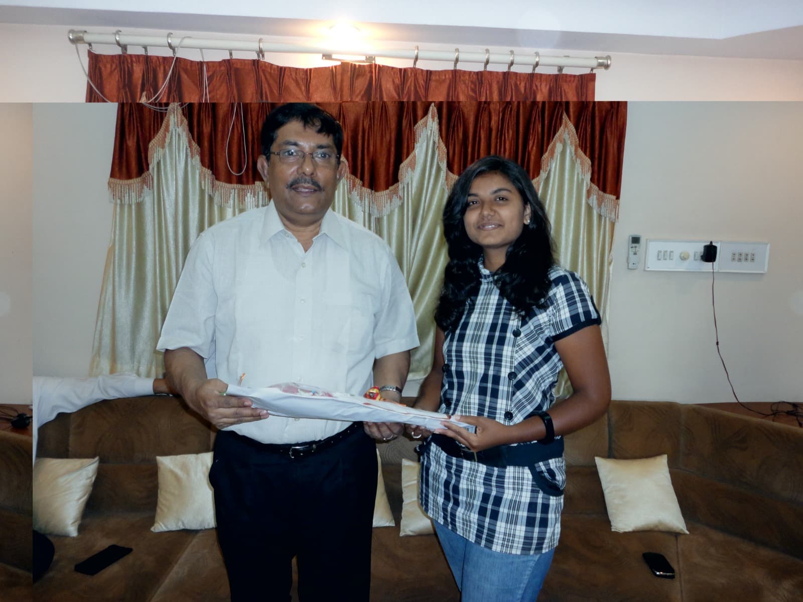 Dr. Dhara Dani receiving blessings from a distinguished leader