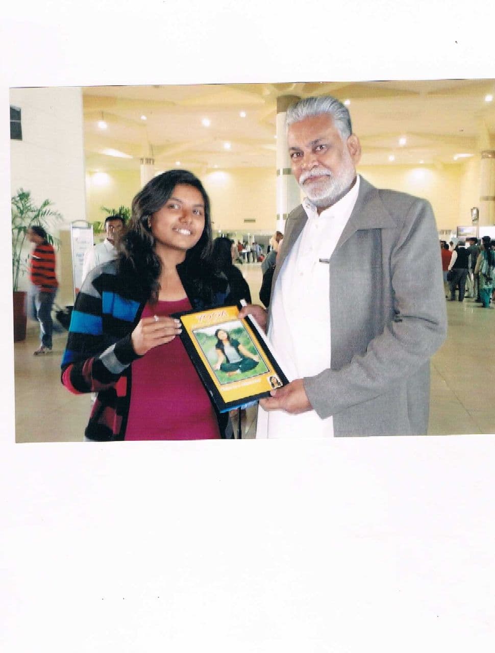 Dr. Dhara Dani presenting Spiritual Yoga book to Parshottam Rupala, Union Minister