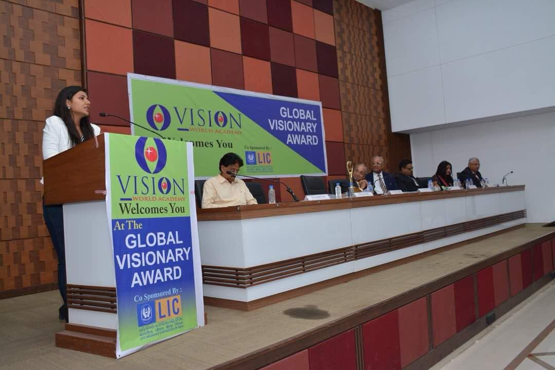 Dr. Dhara Dani speaking at the Global Visionary Award ceremony at Vision World Academy