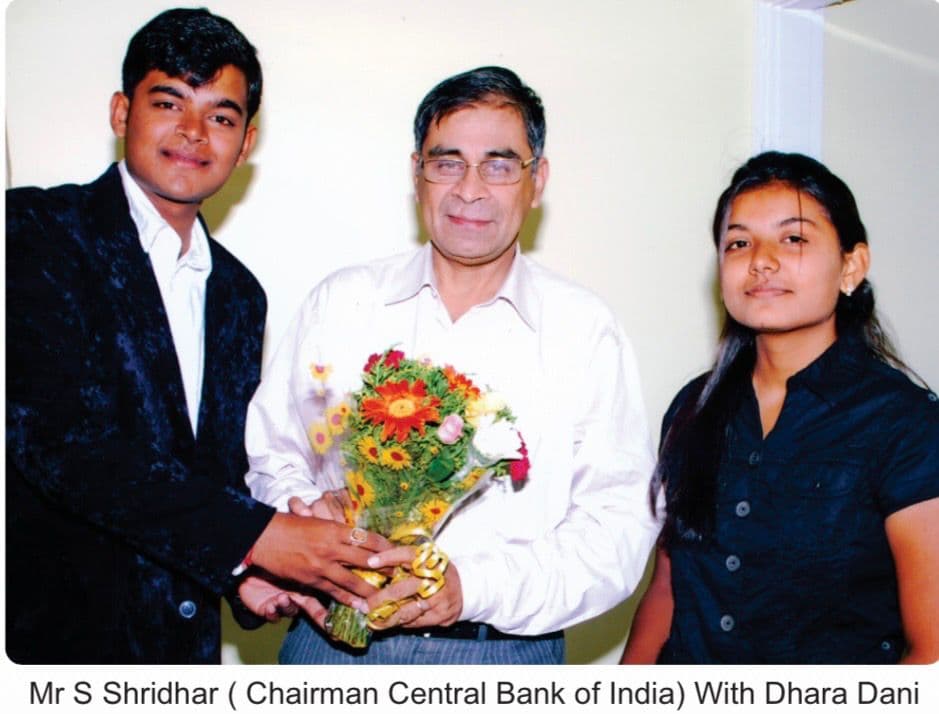 Mr S Shridhar Chairman Central Bank of India with Dhara Dani holding a bouquet of flowers
