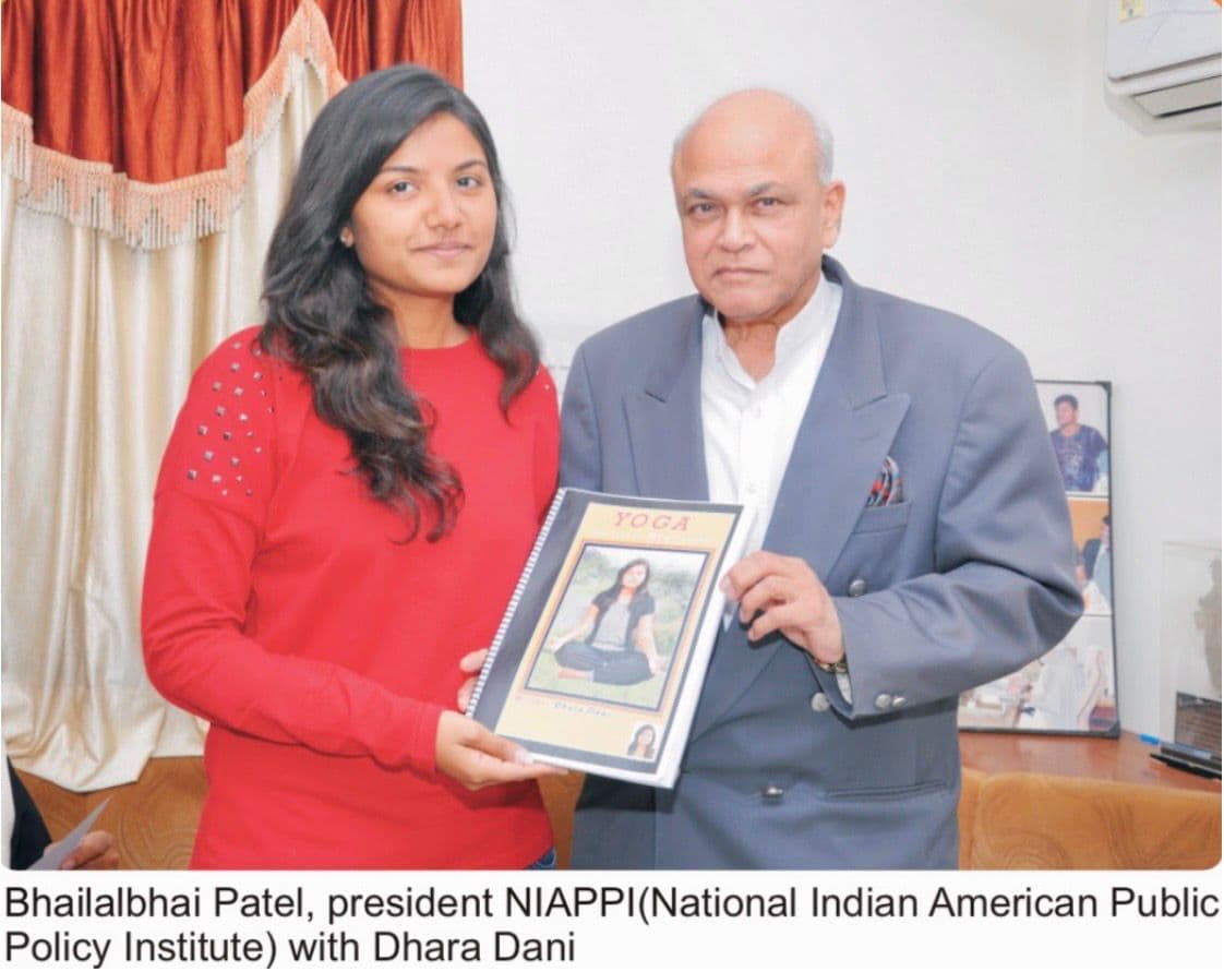 Bhailalbhai Patel President NIAPPI National Indian American Public Policy Institute with Dhara Dani holding YOGA Spiritual Meditation book